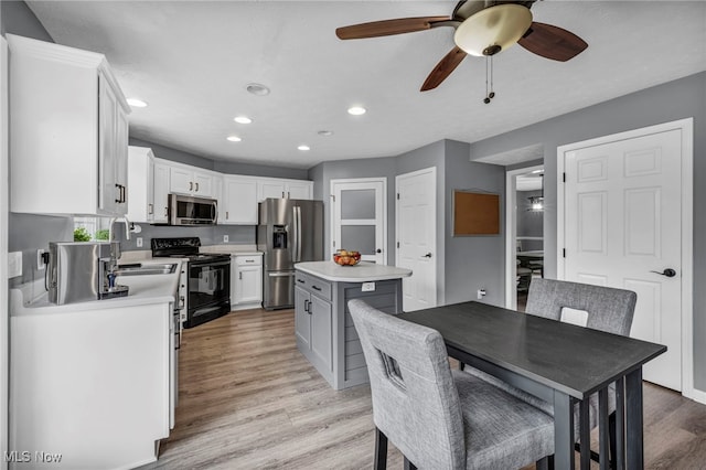 kitchen featuring appliances with stainless steel finishes, a ceiling fan, recessed lighting, and light countertops