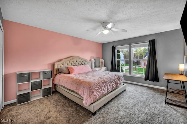 carpeted bedroom featuring baseboards, a ceiling fan, and a textured ceiling