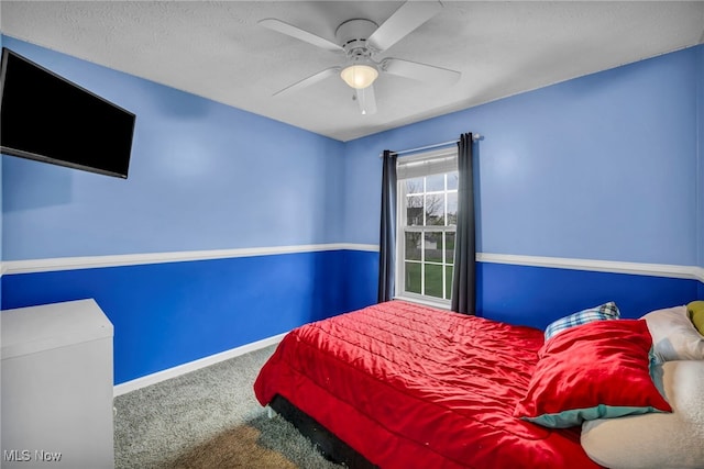 carpeted bedroom featuring baseboards and ceiling fan