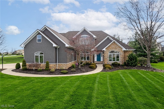 view of front of house featuring a front lawn and stone siding