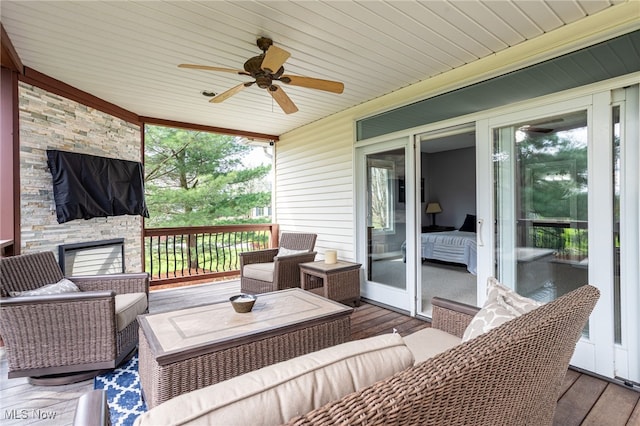 wooden deck featuring an outdoor hangout area and a ceiling fan
