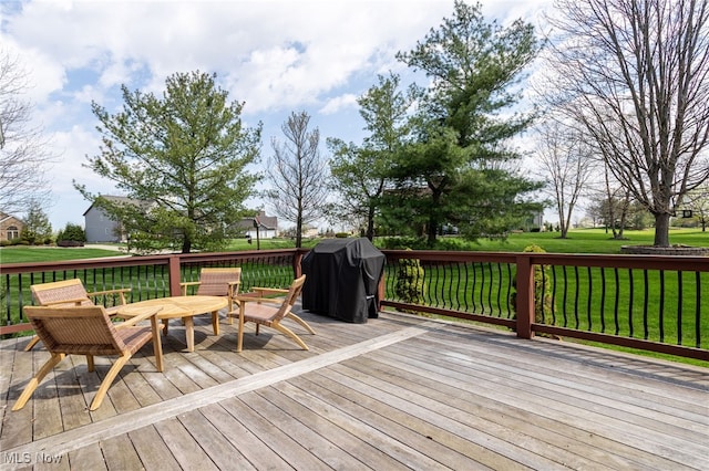 wooden terrace featuring a lawn and a grill
