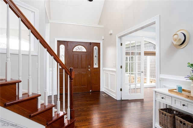 entryway featuring dark wood finished floors, stairs, and a healthy amount of sunlight