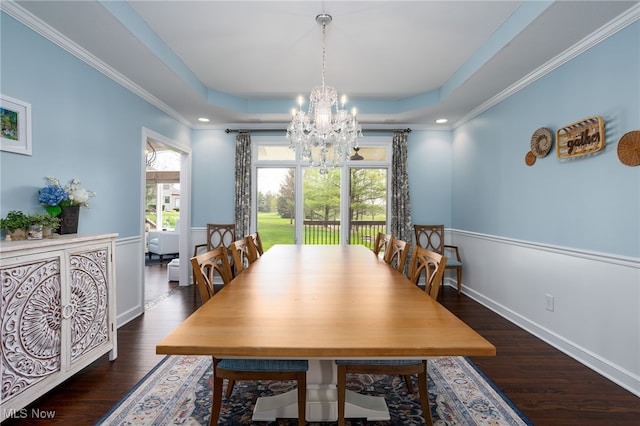 dining space with wood finished floors, a chandelier, and ornamental molding