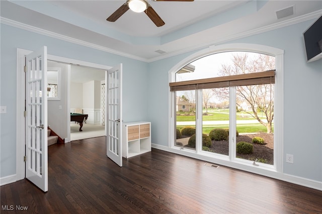 spare room with dark wood finished floors, ceiling fan, and french doors