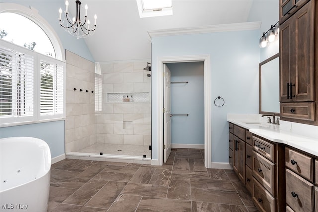 bathroom with baseboards, a freestanding tub, a walk in shower, and vanity