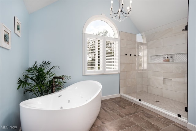 bathroom featuring lofted ceiling, a soaking tub, an inviting chandelier, marble finish floor, and tiled shower