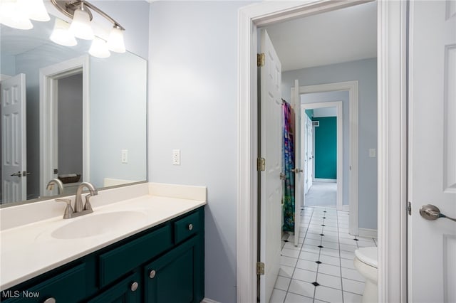 bathroom featuring toilet, vanity, and tile patterned flooring