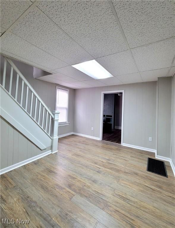 1024 Cleveland St SW, Massillon, OH 44647 - basement featuring baseboards, stairway, wood finished floors, and visible vents