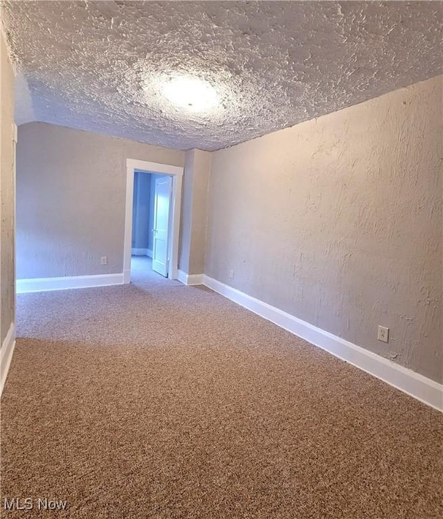 1024 Cleveland St SW, Massillon, OH 44647 - spare room featuring a textured wall, carpet floors, and baseboards