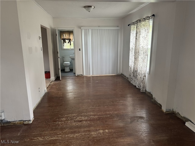 interior space featuring baseboards and wood-type flooring