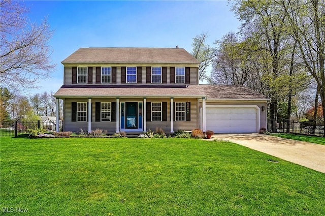 view of front of property with fence, a front lawn, driveway, and an attached garage