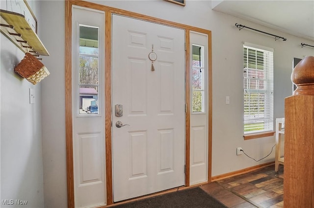 foyer with a wealth of natural light, wood finished floors, and baseboards