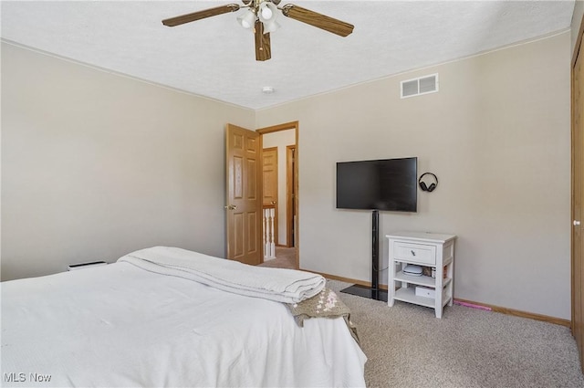 bedroom featuring light colored carpet, visible vents, a ceiling fan, and baseboards