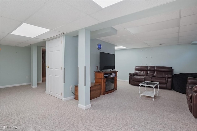 carpeted living area featuring a paneled ceiling and baseboards