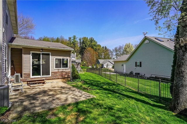 view of yard with a patio area, central air condition unit, entry steps, and a fenced backyard