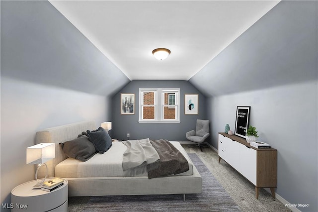 bedroom with baseboards, carpet flooring, and vaulted ceiling