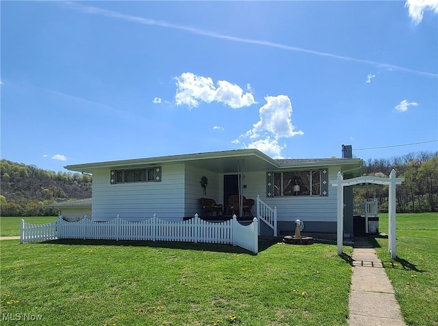 bungalow-style house with fence and a front yard