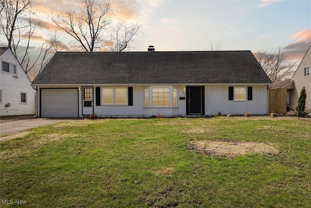 ranch-style home with a garage, a lawn, board and batten siding, roof with shingles, and concrete driveway