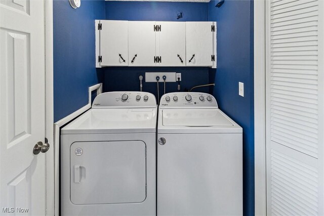 laundry room with cabinet space and washing machine and dryer
