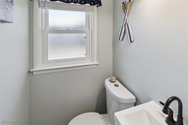 bathroom featuring toilet and a sink