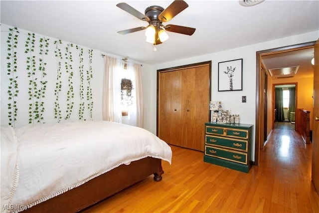 bedroom with a closet, a ceiling fan, and light wood-type flooring