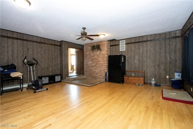 living area with visible vents, a ceiling fan, and light wood-style floors
