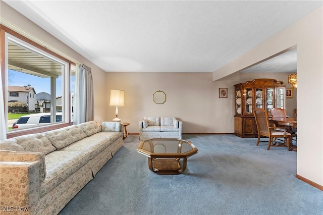 living area featuring carpet floors and baseboards