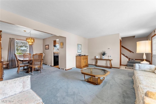 living room featuring baseboards, carpet flooring, and a chandelier