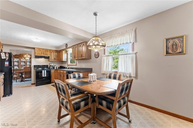 dining area with baseboards, light floors, and a chandelier