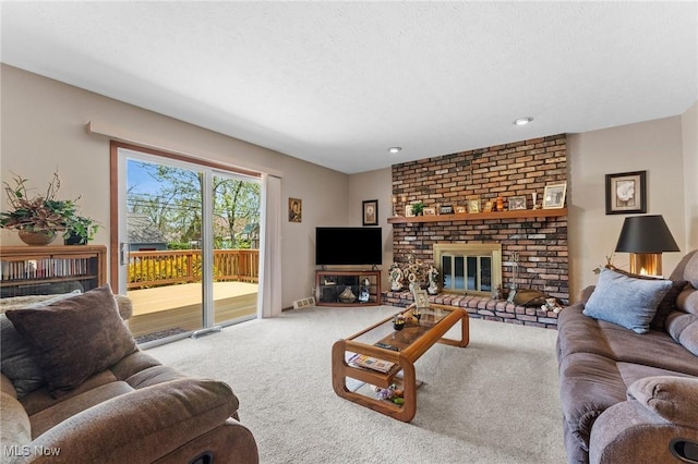 carpeted living area with recessed lighting and a fireplace