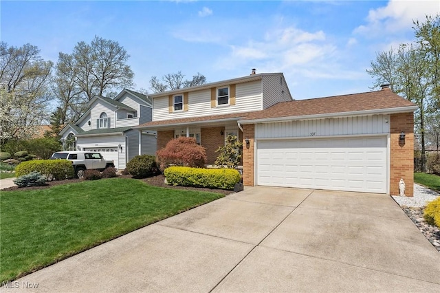 traditional-style home with a front lawn, a chimney, brick siding, an attached garage, and driveway