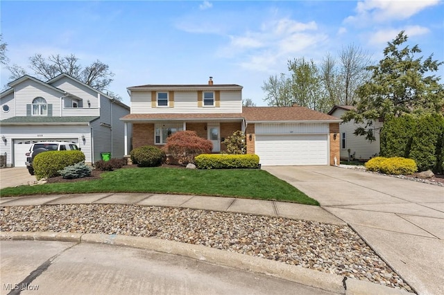traditional-style home with brick siding, a garage, a front lawn, and driveway