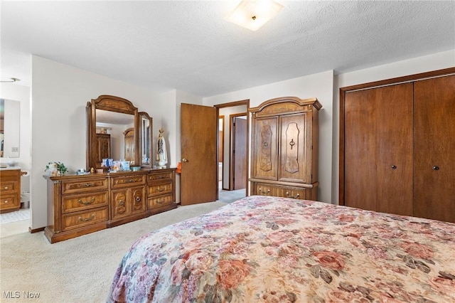 bedroom with carpet floors, a textured ceiling, and a closet