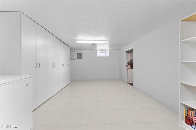 below grade area featuring a textured ceiling and electric panel