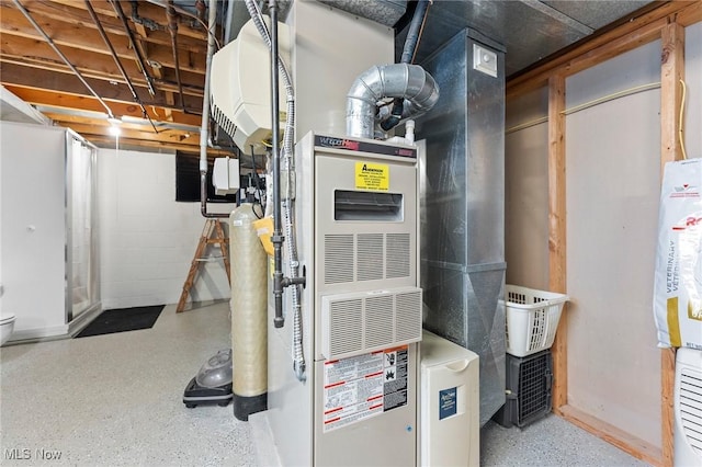utility room featuring heating unit