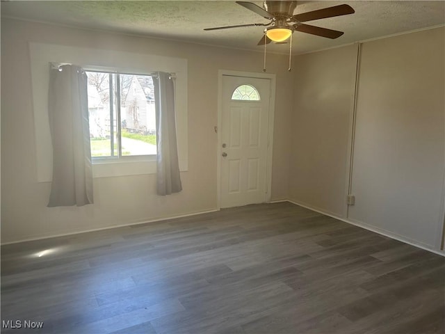 13505 Carrington Ave, Cleveland, OH 44135 - foyer entrance featuring baseboards, ceiling fan, a textured ceiling, and dark wood-type flooring