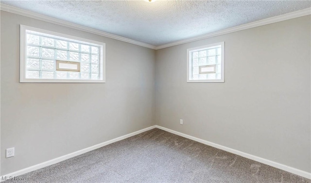 unfurnished room with ornamental molding, a textured ceiling, carpet floors, and baseboards