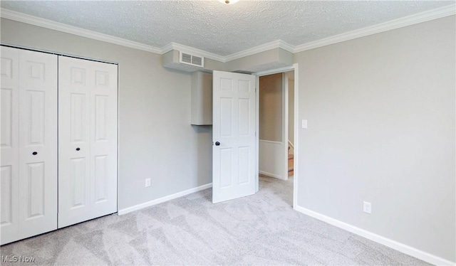 unfurnished bedroom featuring visible vents, a closet, baseboards, and carpet floors