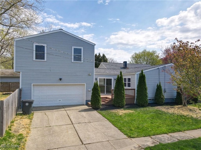 traditional-style house featuring fence, a garage, a wooden deck, a front yard, and concrete driveway