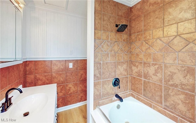 full bathroom with washtub / shower combination, vanity, and ornamental molding