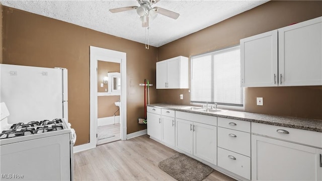 636-638 Fern St, Akron, OH 44307 - kitchen featuring white appliances, a textured ceiling, ceiling fan, and white cabinetry