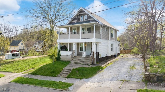 636-638 Fern St, Akron, OH 44307 - view of front of property with a porch, driveway, a front lawn, and a balcony