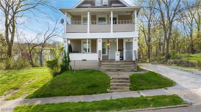 636-638 Fern St, Akron, OH 44307 - view of front of home with a porch, a balcony, gravel driveway, and a front yard