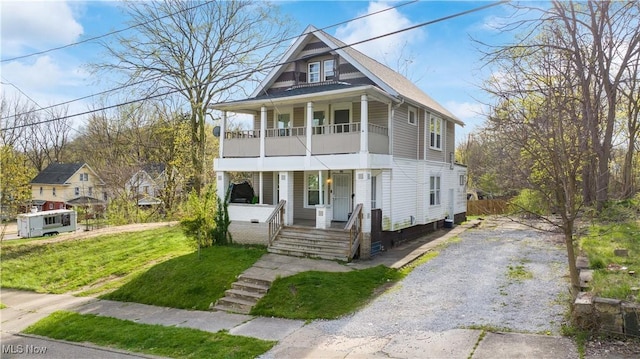 636-638 Fern St, Akron, OH 44307 - view of front of property featuring a porch, a balcony, a front yard, and driveway