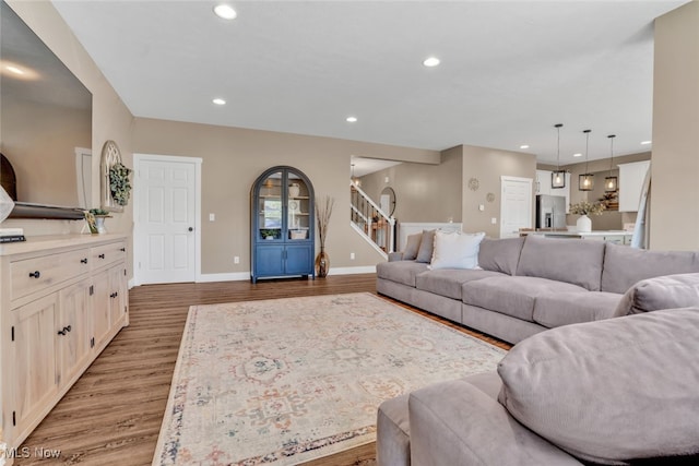 4591 Boulder Ln, Lorain, OH 44053 - living room featuring recessed lighting, light wood-type flooring, baseboards, and stairs