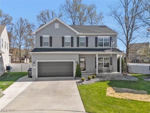 4591 Boulder Ln, Lorain, OH 44053 - view of front facade featuring an attached garage, a porch, driveway, and a front lawn