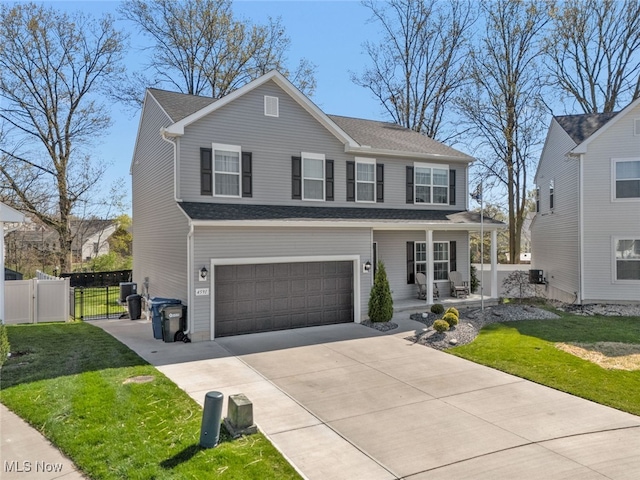 4591 Boulder Ln, Lorain, OH 44053 - view of front of home with a gate, a garage, a porch, driveway, and a shingled roof