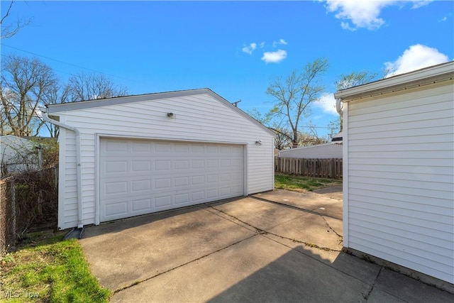 detached garage featuring fence