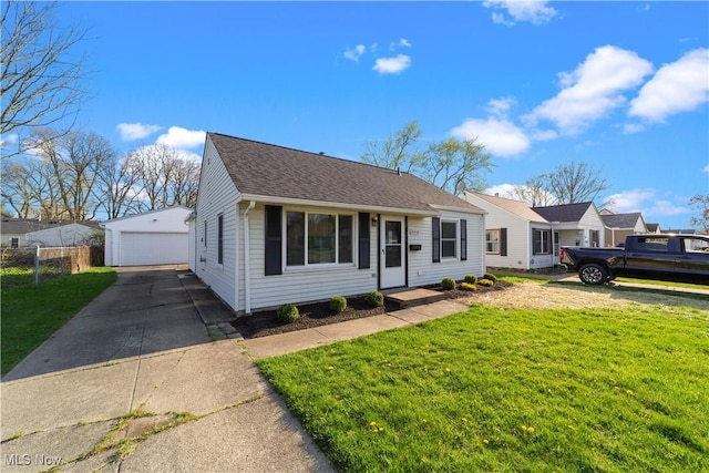 view of front of home featuring an outbuilding, a detached garage, a front lawn, and fence
